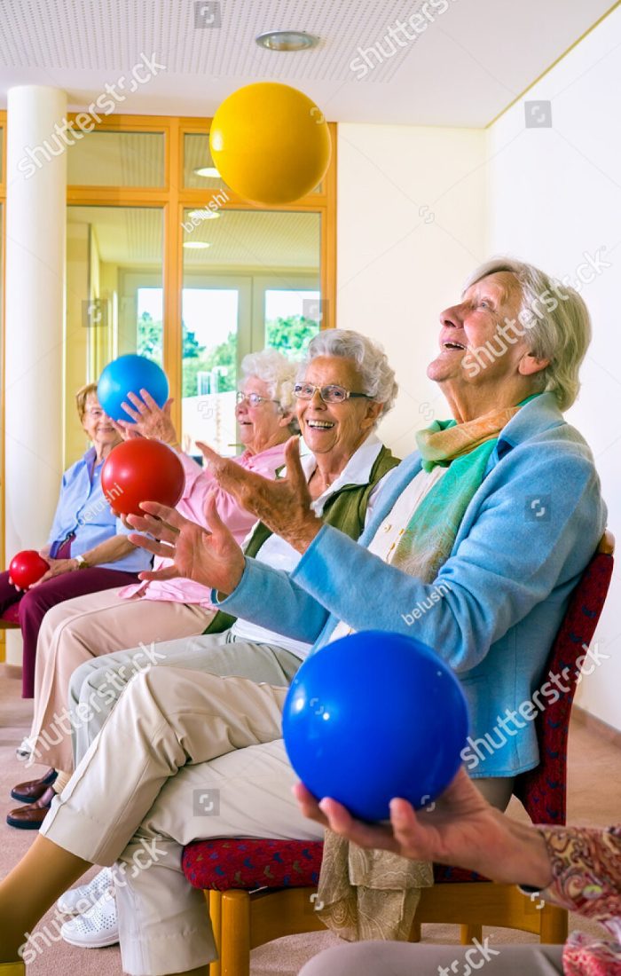 stock-photo-group-of-happy-elderly-ladies-in-a-seniors-gym-doing-hand-coordination-exercises-throwing-and-367739975